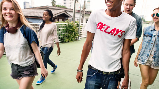 Group of young friends walking outdoors, smiling and enjoying casual time together in a vibrant setting