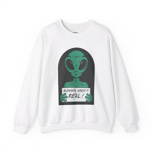 White sweatshirt featuring a green alien holding a sign that reads "Humans Aren't Real!" with a sarcastic tone.