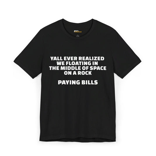 Black unisex tee featuring bold white text 'Y’all Ever Realized We Floating in the Middle of Space on a Rock Paying Bills,' ideal for those who appreciate sarcasm.