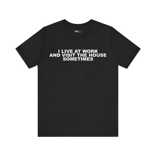 Black tee for men and women featuring a sarcastic 'I Live at Work' design, great for anyone who feels they work too much.