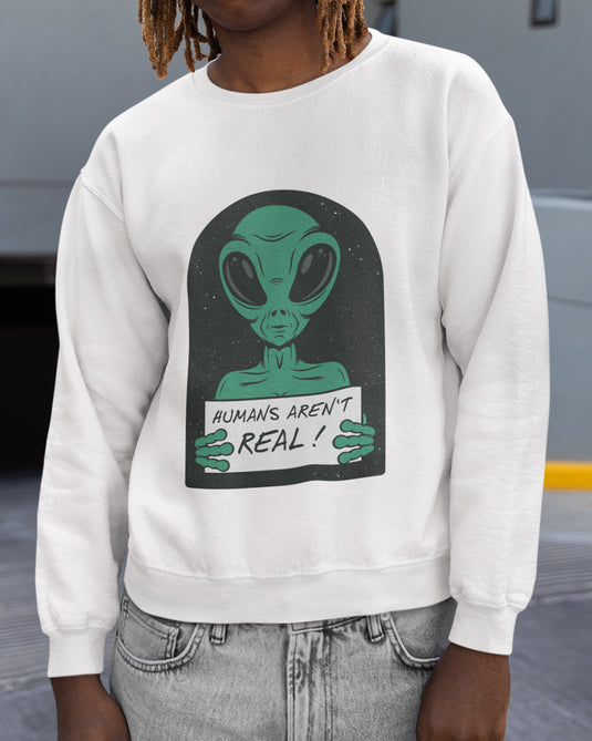 White funny graphic sweatshirt with "Humans Aren't Real" alien design, perfect for humor lovers and bold statement fashion fans.