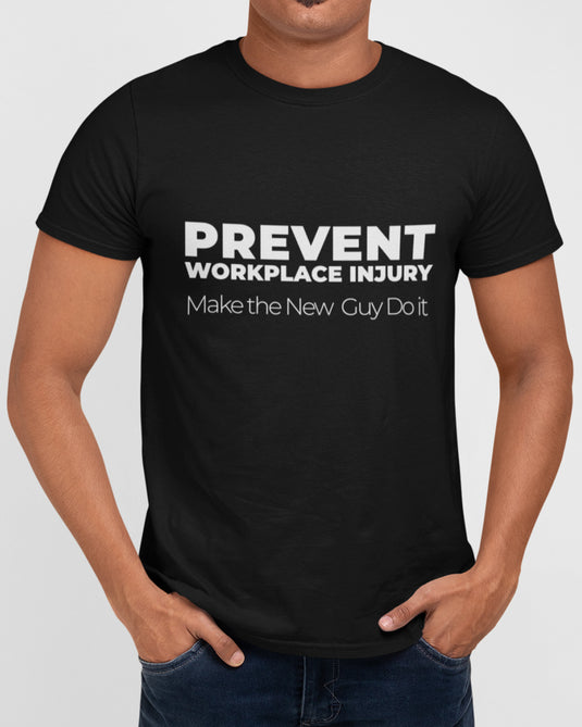 Black graphic tee with sarcastic text "Prevent Workplace Injury, Make the New Guy Do It" in bold and minimalist font.