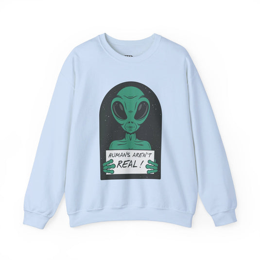 Light blue sweatshirt with a humorous graphic of a green alien holding a sign stating "Humans Aren't Real!"