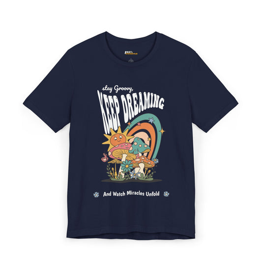 Navy t-shirt with a psychedelic design featuring mushrooms, rainbows, and the message "Keep Dreaming.