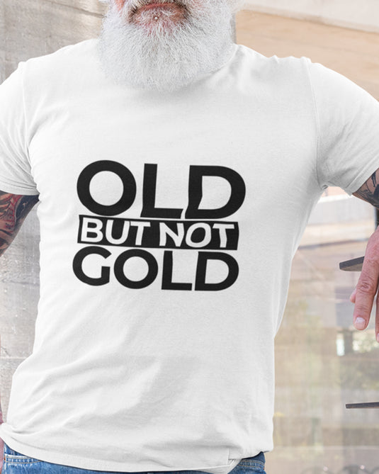 White graphic T-shirt featuring bold "Old But Not Gold" text, ideal for humorous and sarcastic fashion enthusiasts.