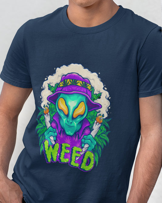 Navy blue graphic tee featuring a colorful alien character holding two lit joints, surrounded by smoke and cannabis leaves, with bold text "Weed."