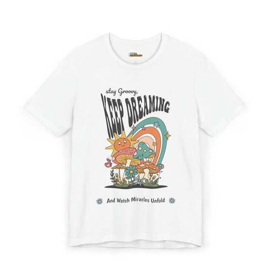 White t-shirt with a colorful psychedelic design and the positive message "Keep Dreaming," perfect for rave lovers.